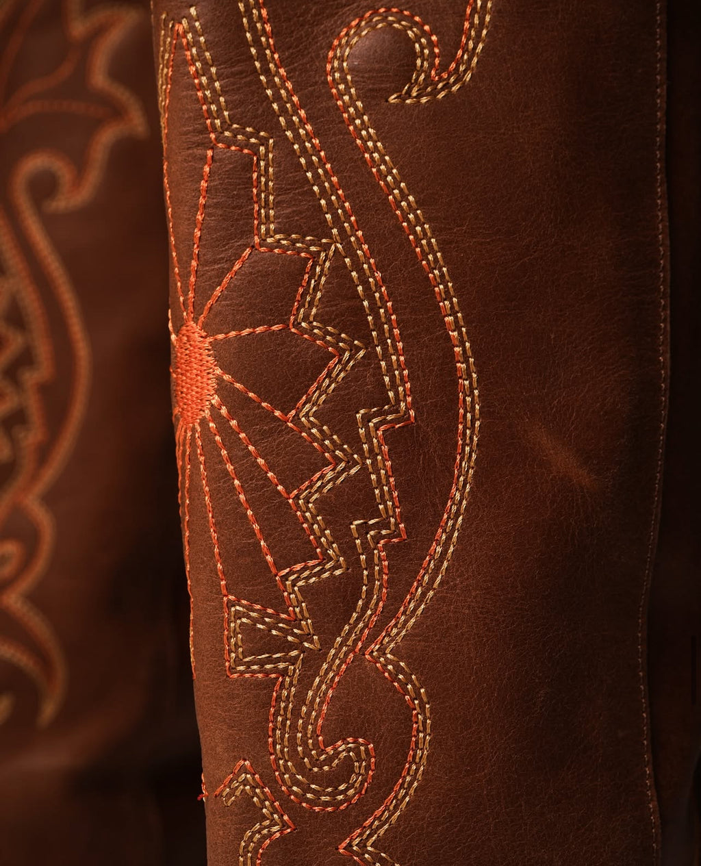 Tall tan cowboy boots with pointed toes, angled heels, and subtle Western embroidery along the shaft. A sleek and edgy twist on a classic silhouette, perfect for bold, versatile styling.