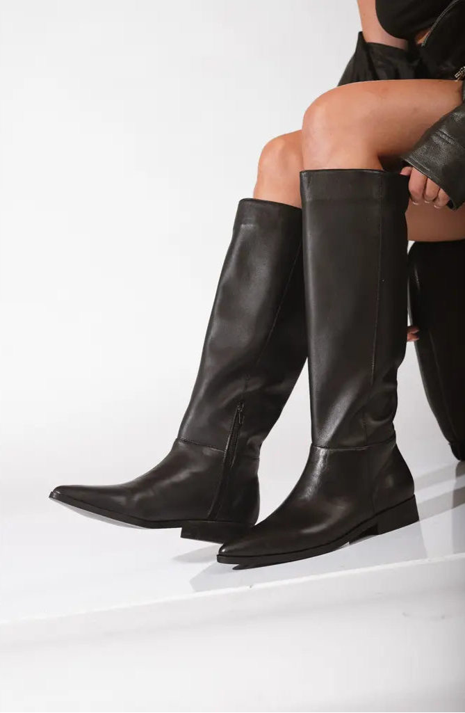 Women's sleek black leather knee-high boots with pointed toe and side zipper, minimalist and modern design for everyday or dressy wear