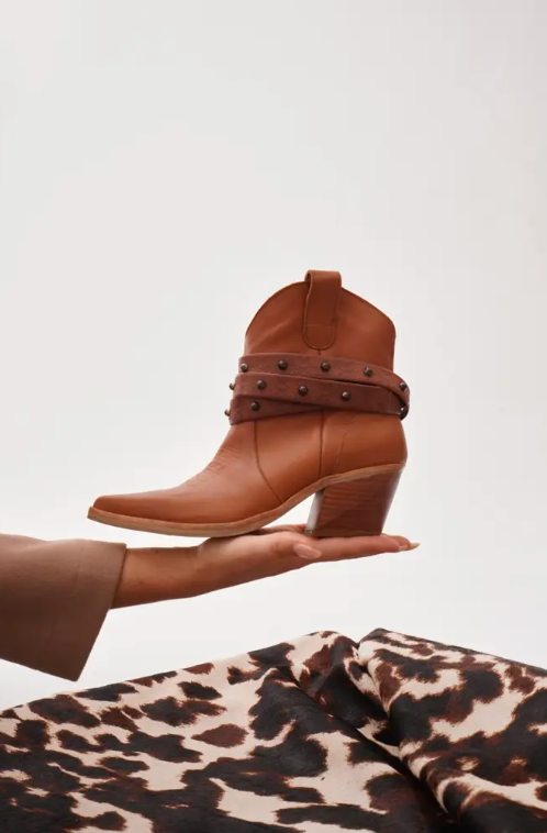 Women's tan leather western ankle boots with brown studded straps and block heel