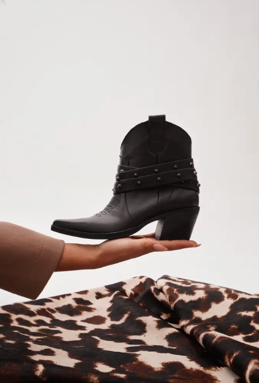 Women's black leather western ankle boots with studded wrap-around straps and block heel