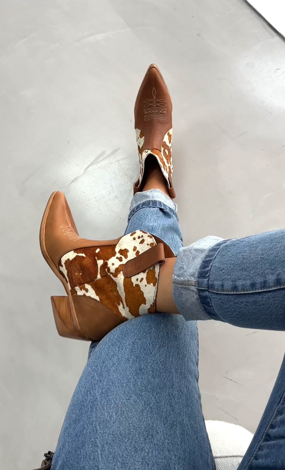 Women's brown and white cowhide leather western ankle boots with pointed toe and low wooden heel