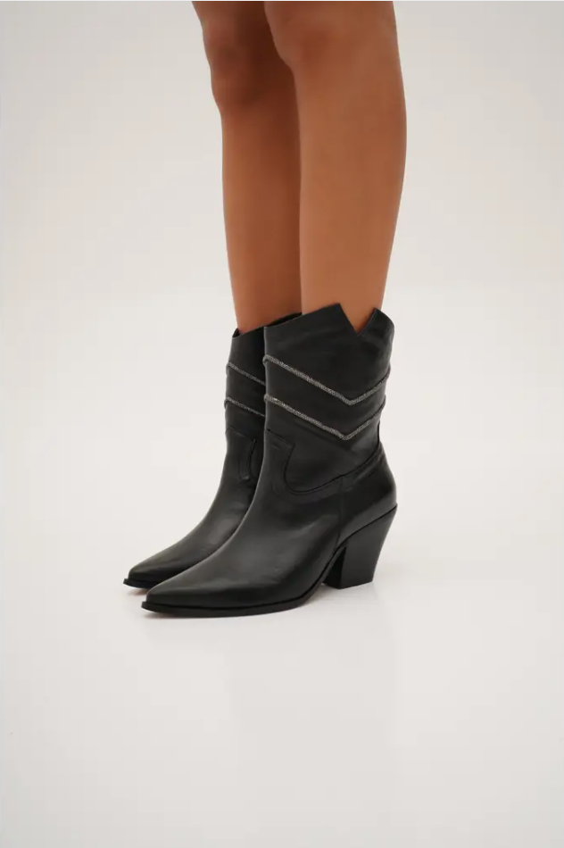 Sleek black mid-calf cowboy boots with pointed toes, angled block heels, and silver embroidered chevron stitching. These modern western boots blend classic style with a chic, minimalist edge.