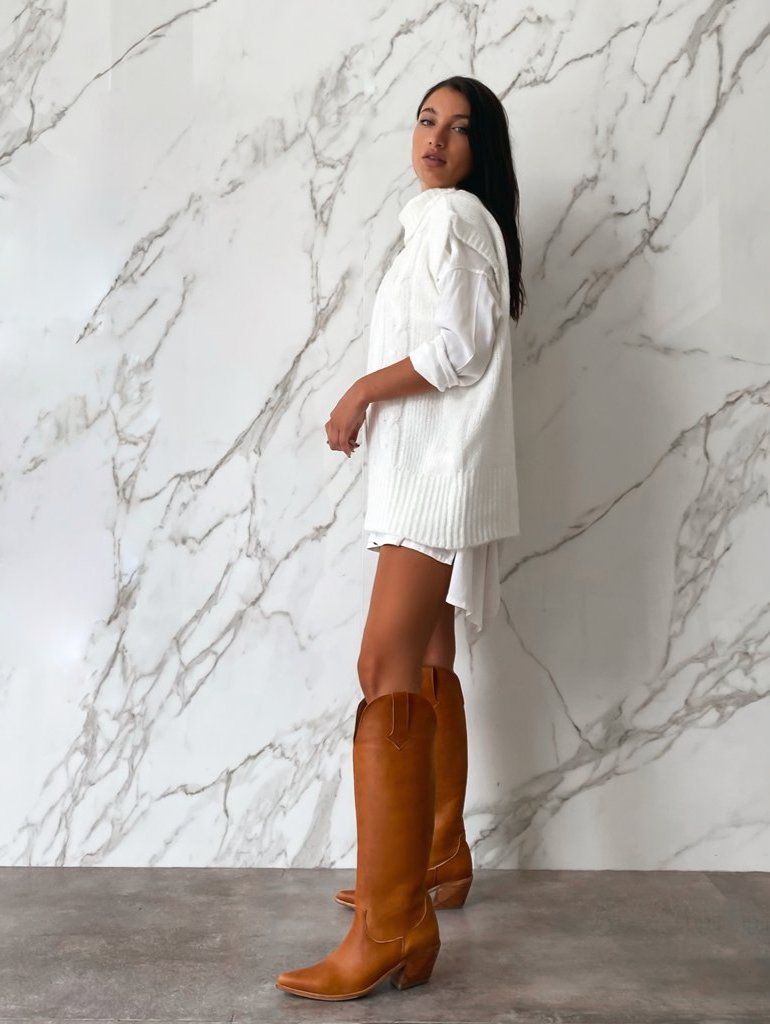 Sleek knee-high tan leather boots with a subtle Western silhouette, square toes, and mid-height block heels. A modern, minimalist design ideal for versatile day-to-night styling.