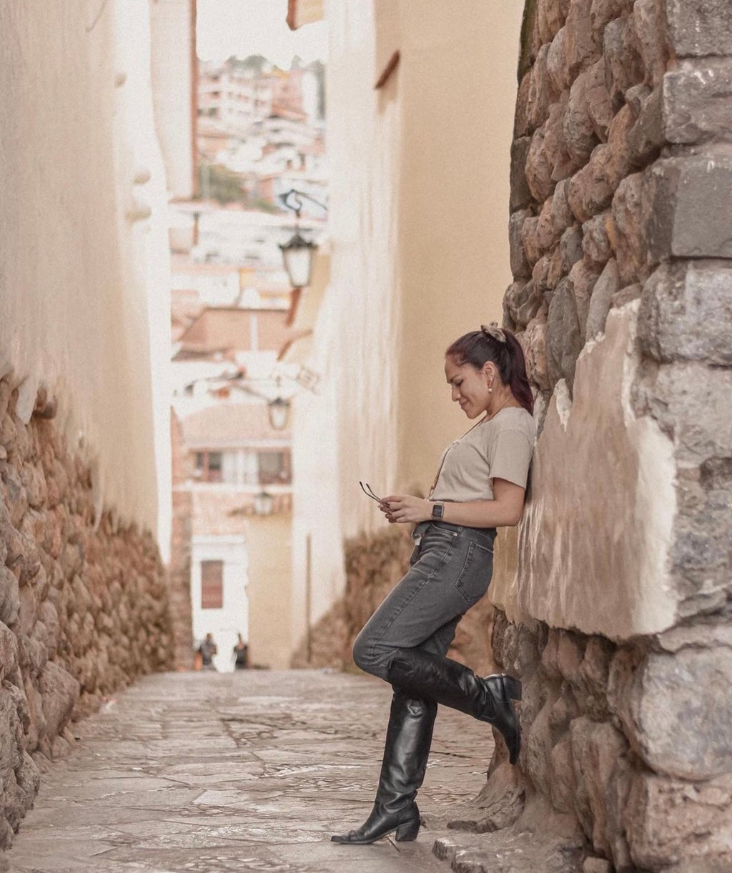 Sleek knee-high black leather boots with a subtle Western silhouette, square toes, and mid-height block heels. A modern, minimalist design ideal for versatile day-to-night styling.